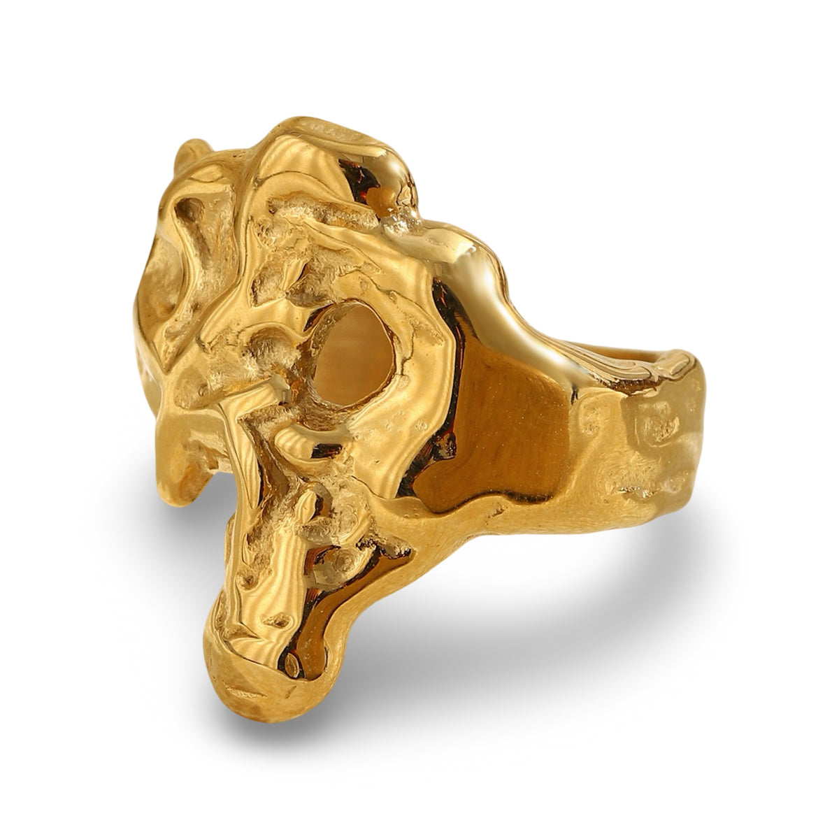 A chunky, organic-shaped gold ring with a highly textured, sculptural surface resembling a stylized skull or abstract bone.