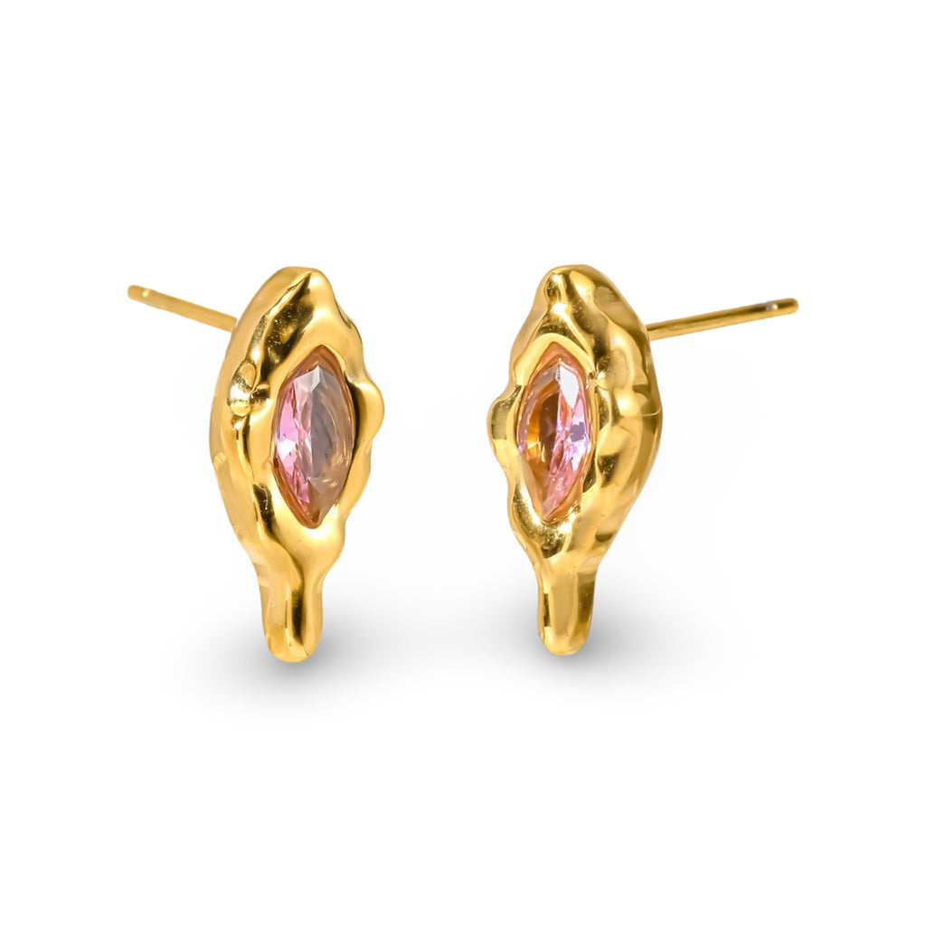 A pair of gold stud earrings with an organic, melting-puddle shape and a marquise-cut pink gemstone in the center, shown on a clean white background.