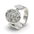 A textured oval ring featuring a raised relief design with an embossed tree motif.