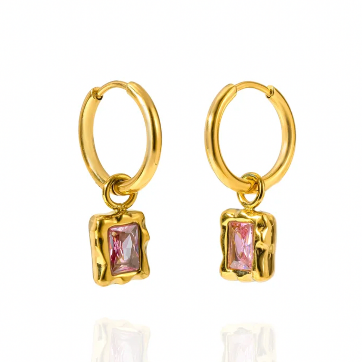 A pair of gold hoop earrings with a small, textured gold rectangular bezel setting holding a cubic zironia marquise-cut gemstone. 